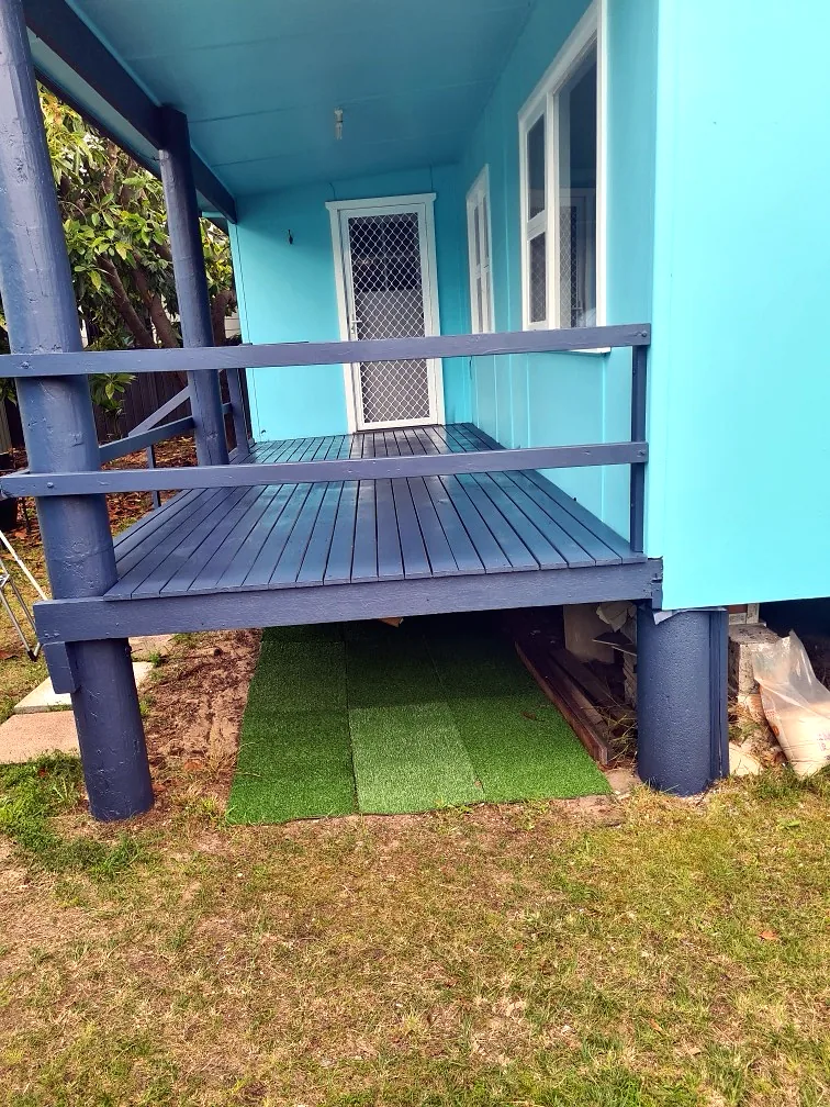 Blue deck and weatherboards freshly coated
